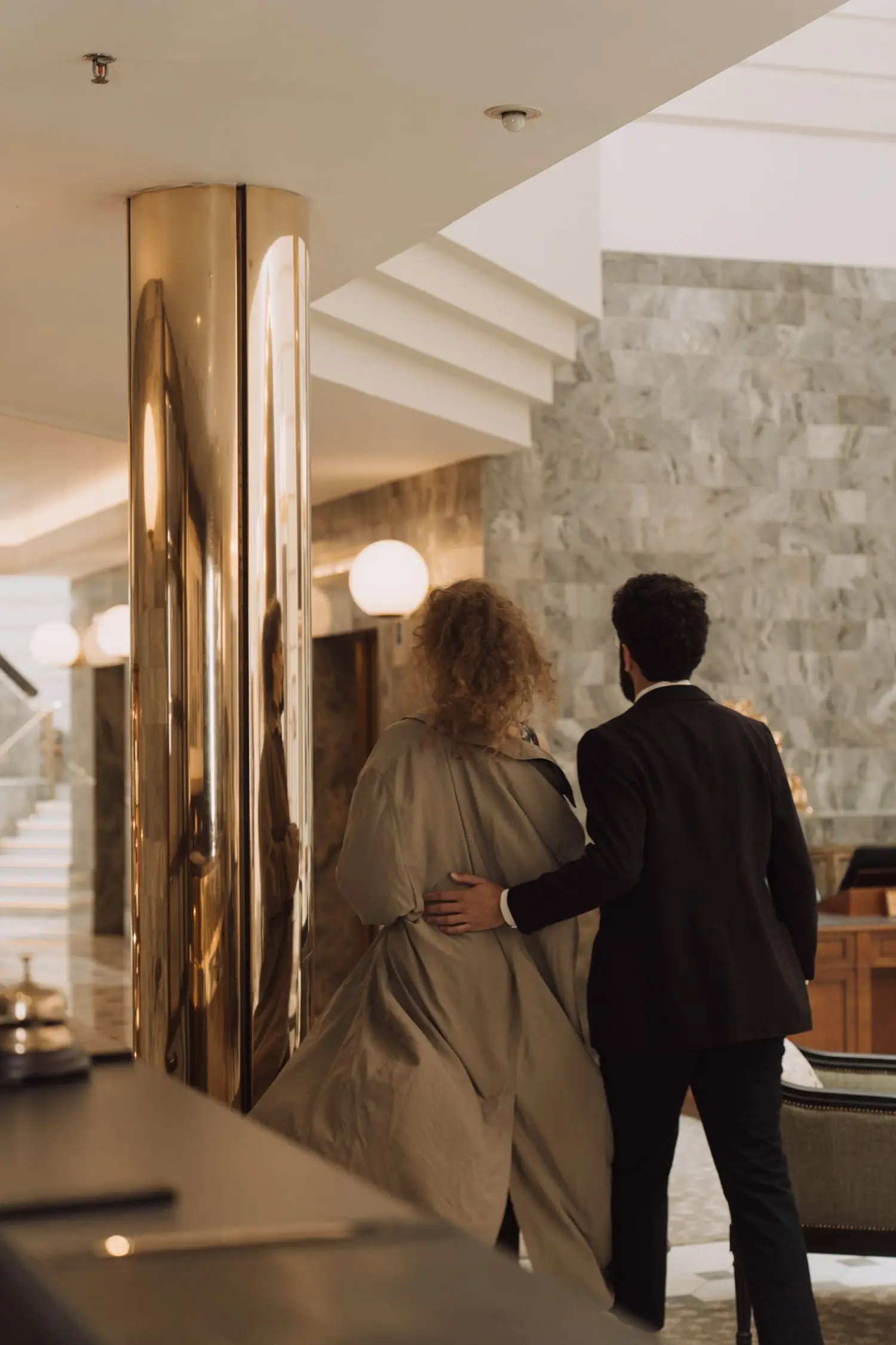 Couple walking through a refined hotel corridor